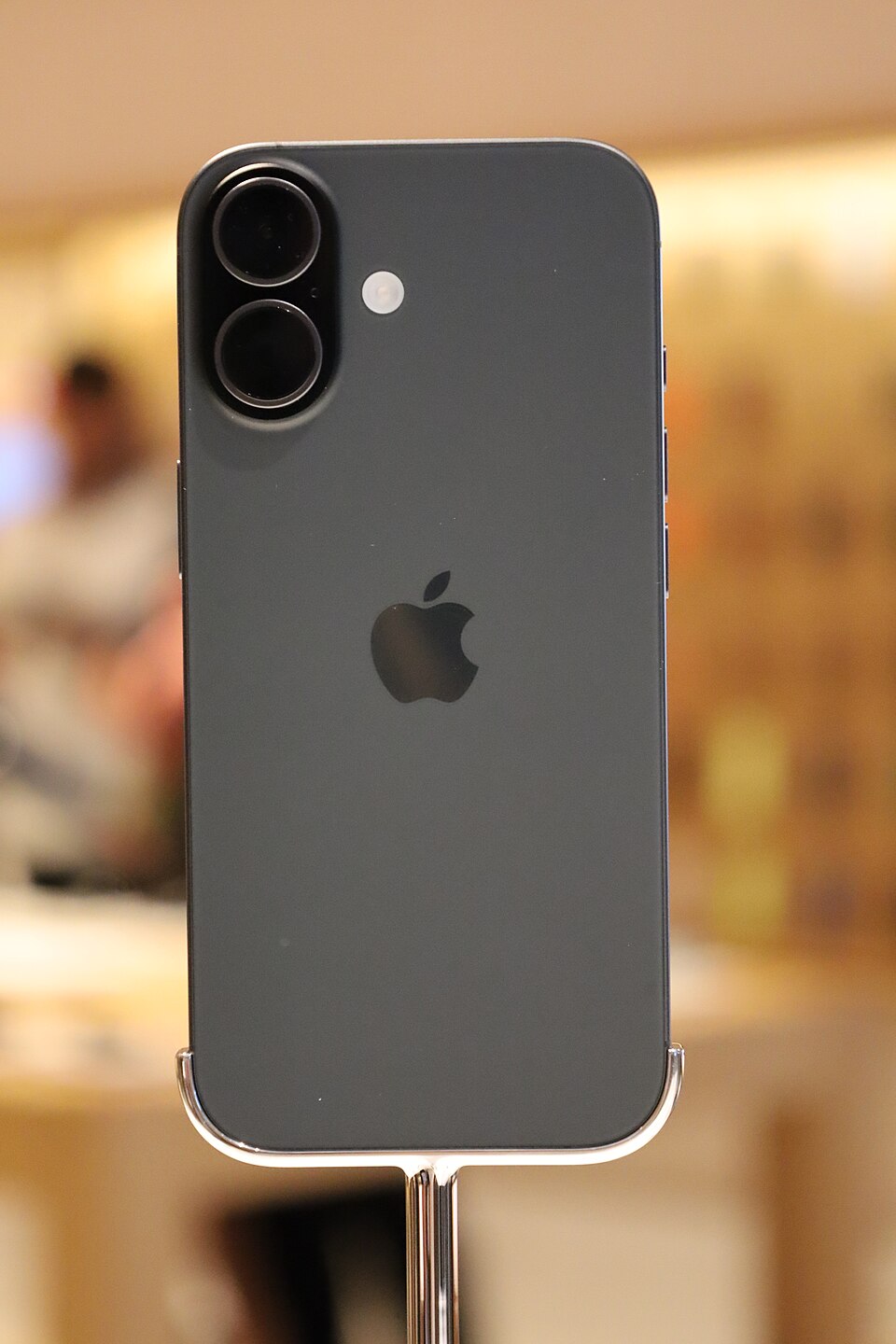 A black iPhone 17 on display